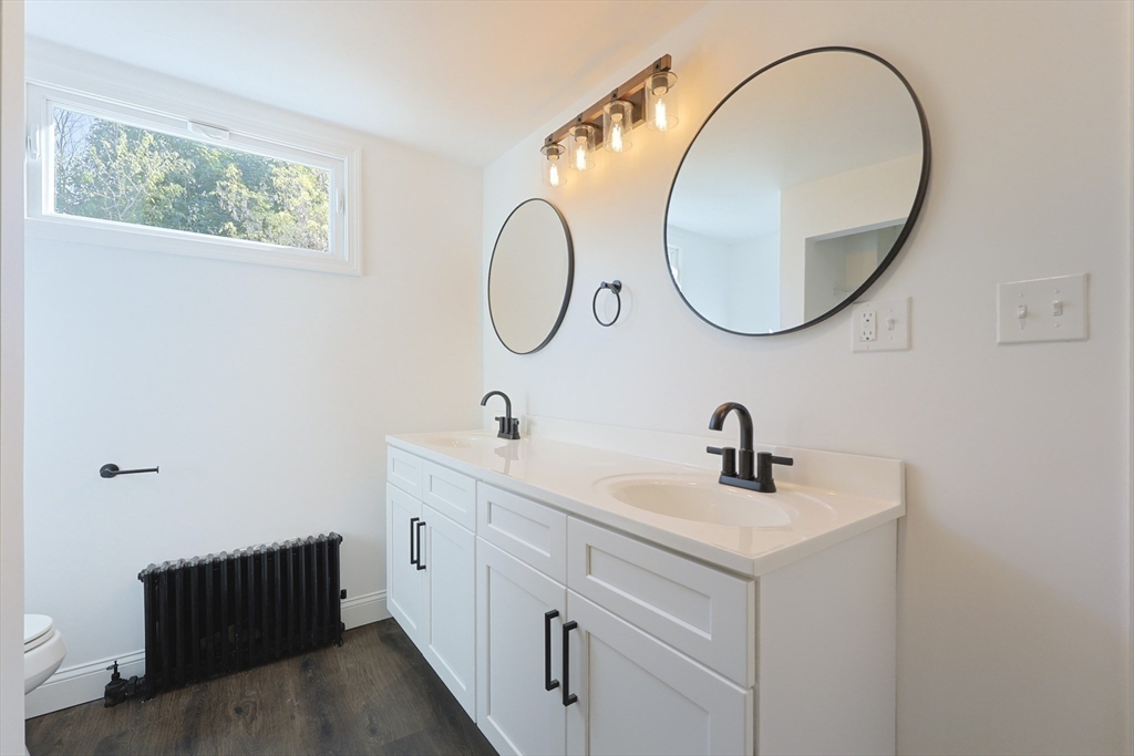 21 Irving Street Bellingham, MA 02019 - Photo 24 of 39 a bathroom with a sink and a mirror