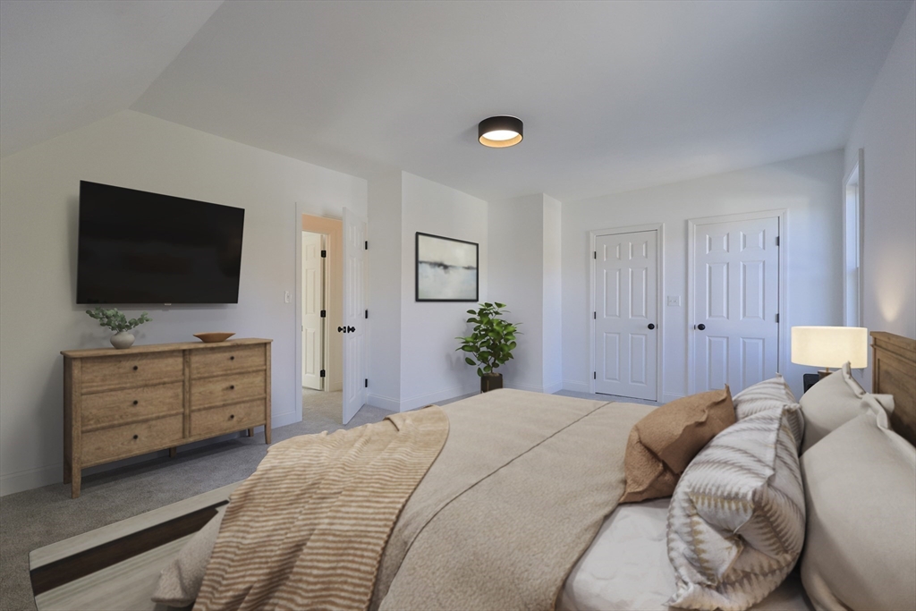 21 Irving Street Bellingham, MA 02019 - Photo 27 of 39 a bedroom with a bed and a flat screen tv in white walls