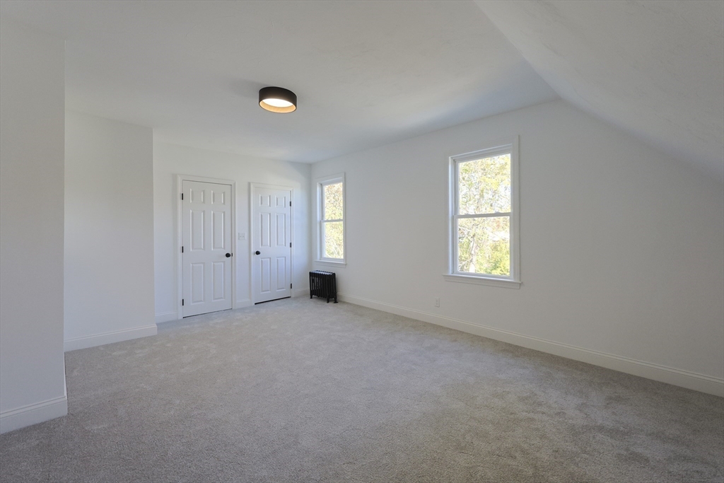 21 Irving Street Bellingham, MA 02019 - Photo 30 of 39 an empty room with windows and closet