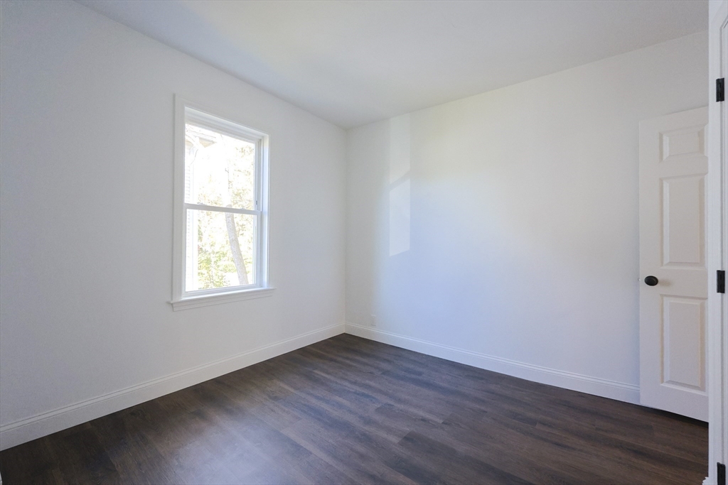 21 Irving Street Bellingham, MA 02019 - Photo 38 of 39 an empty room with wooden floor and windows