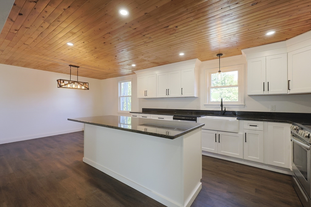 21 Irving Street Bellingham, MA 02019 - Photo 10 of 39 a kitchen with granite countertop a sink and cabinets