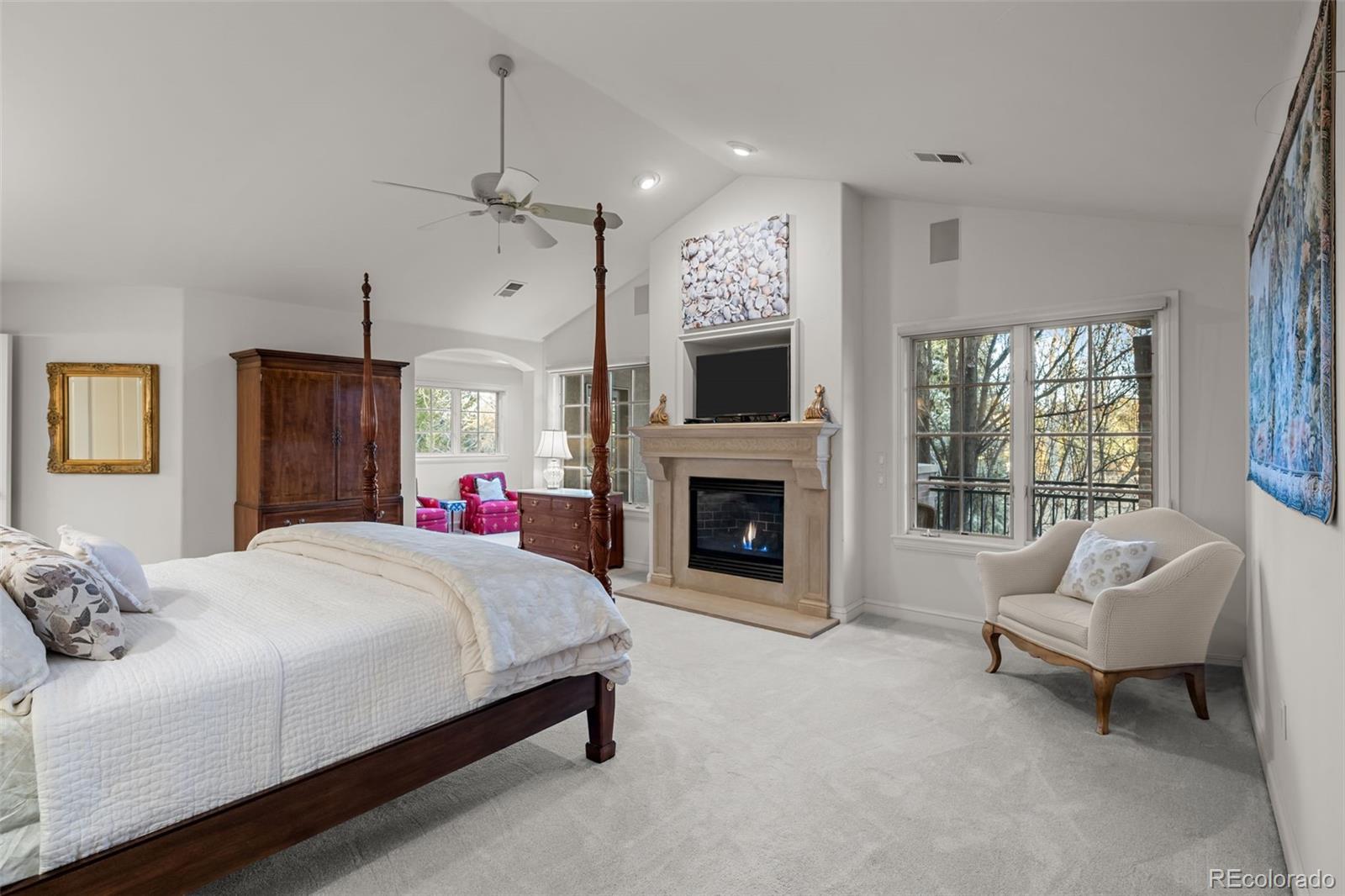 5 Redhawk Run Cherry Hills Village, CO 80113 - Photo 15 of 35 a spacious bedroom with a bed and a fireplace