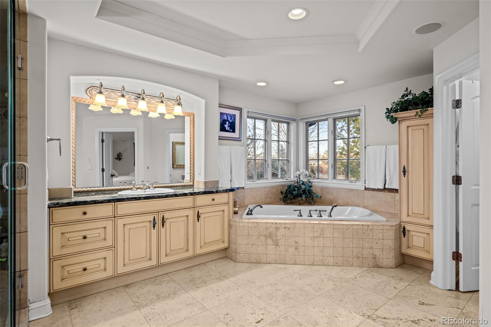 5 Redhawk Run Cherry Hills Village, CO 80113 - Photo 19 of 35 a spacious bathroom with a tub sink and mirror