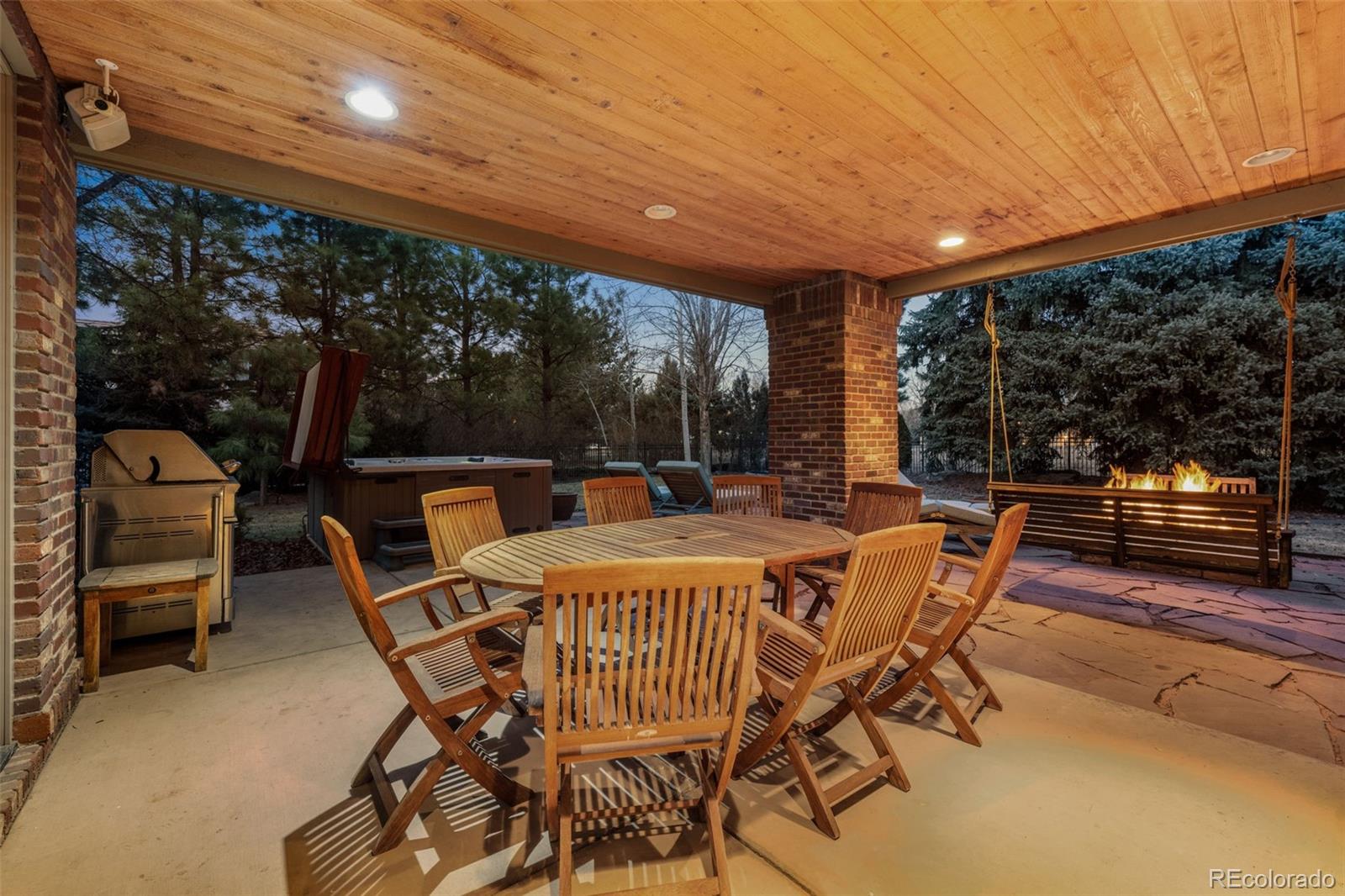 5 Redhawk Run Cherry Hills Village, CO 80113 - Photo 30 of 35 a patio with yard glass top table and chairs