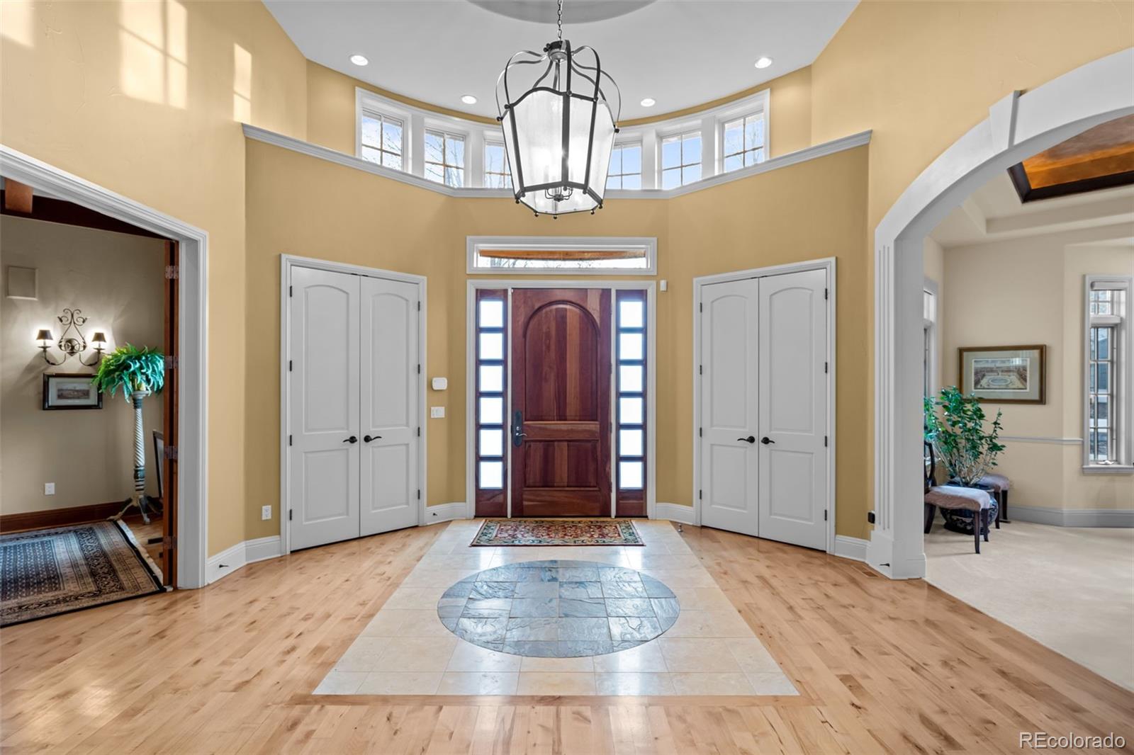 5 Redhawk Run Cherry Hills Village, CO 80113 - Photo 3 of 35 a view of a hallway with wooden floor and staircase
