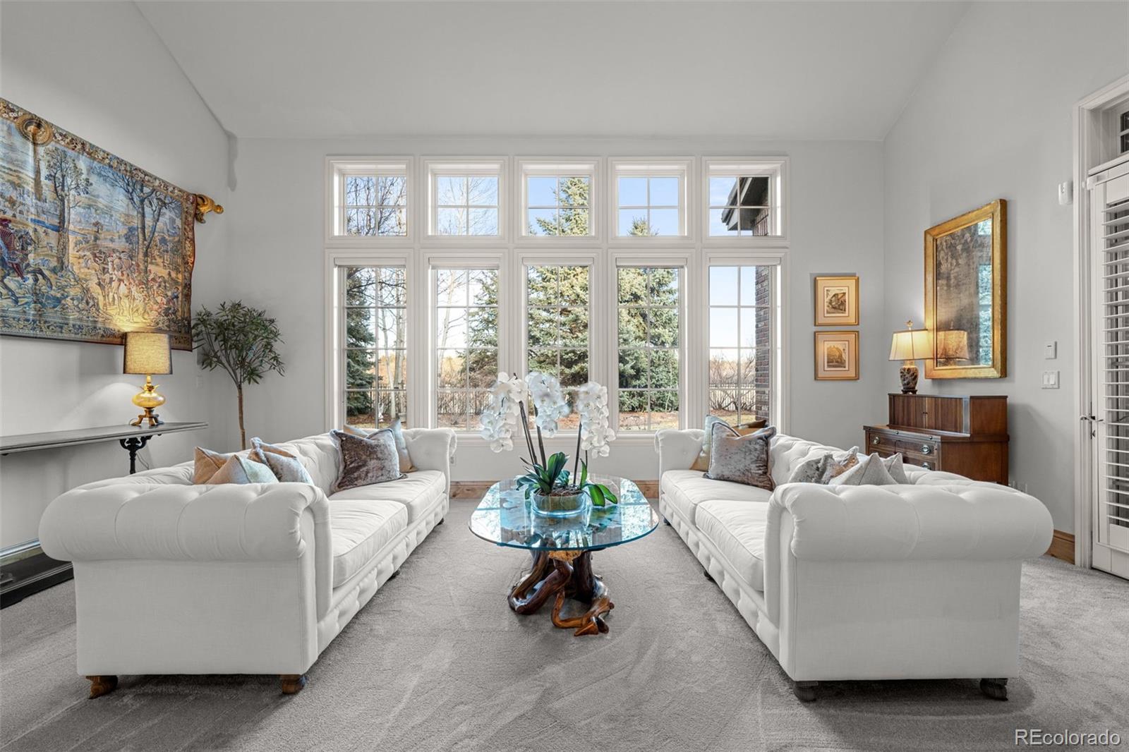 5 Redhawk Run Cherry Hills Village, CO 80113 - Photo 6 of 35 a living room with furniture large windows and a table