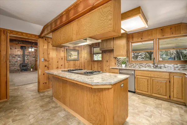 a kitchen with cabinets and a stove