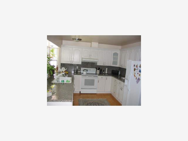 4319 Bristolwood Road Pleasanton, CA 94588 - Photo 5 of 5 a kitchen with stainless steel appliances kitchen island sink refrigerator and microwave