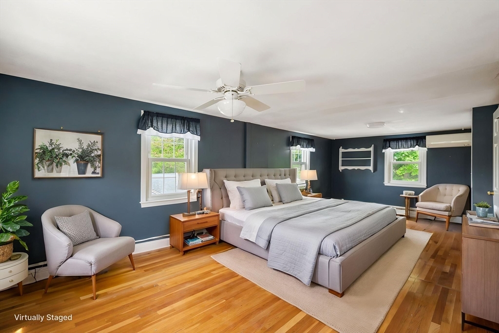 40 Bell Road Weymouth, MA 02188 - Photo 39 of 41 a bedroom with a bed and wooden floor