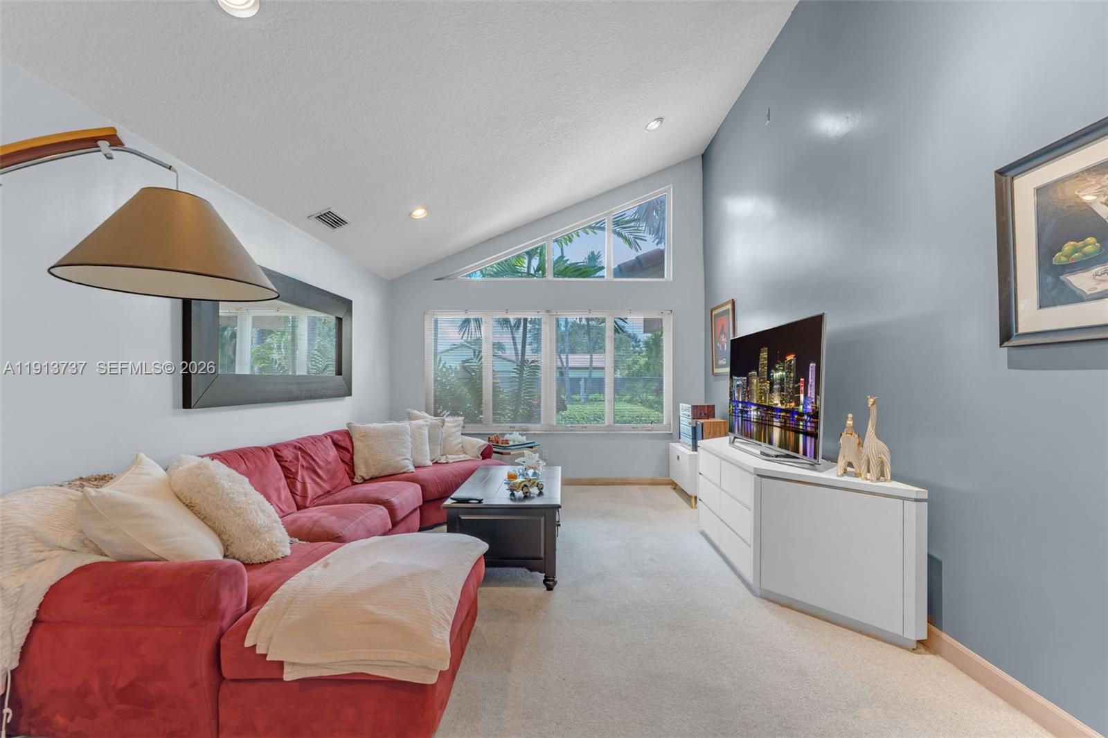 10220 Southwest 140th Street Miami, FL 33176 - Photo 13 of 53 a living room with furniture and a flat screen tv