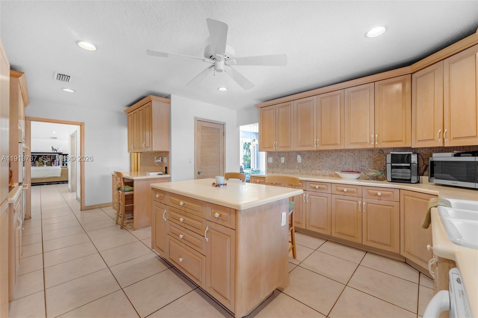 10220 Southwest 140th Street Miami, FL 33176 - Photo 15 of 53 a kitchen with a sink cabinets and window