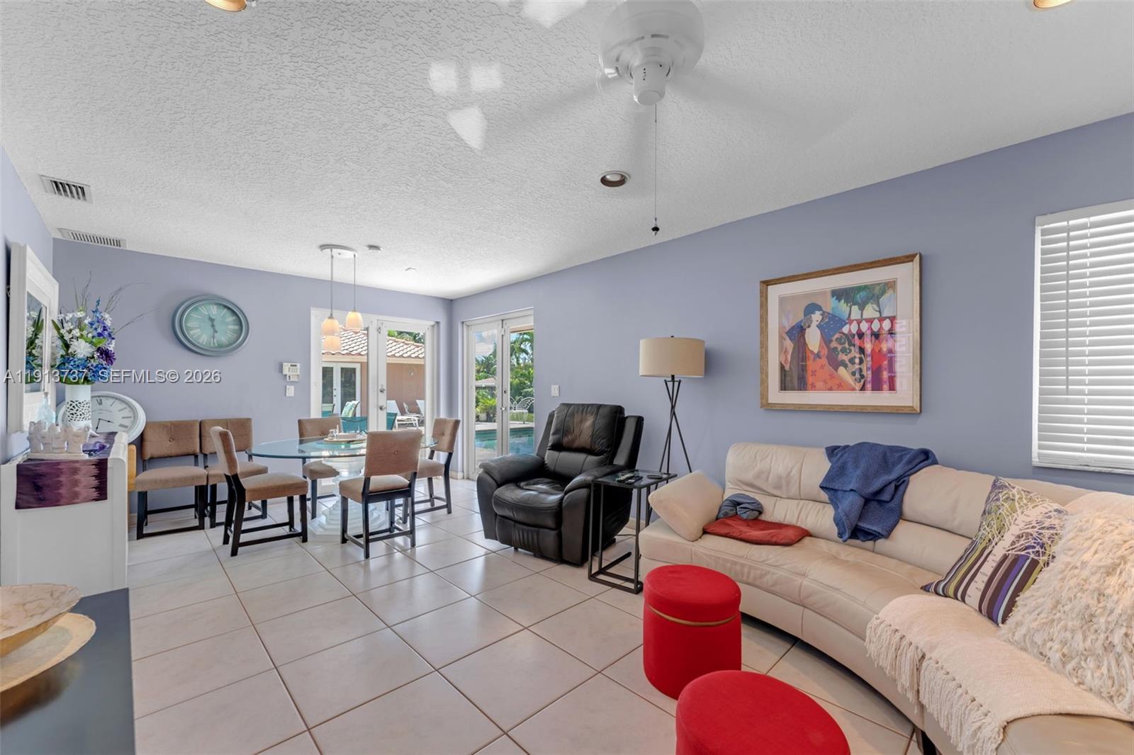 10220 Southwest 140th Street Miami, FL 33176 - Photo 17 of 53 a living room with furniture and a large window