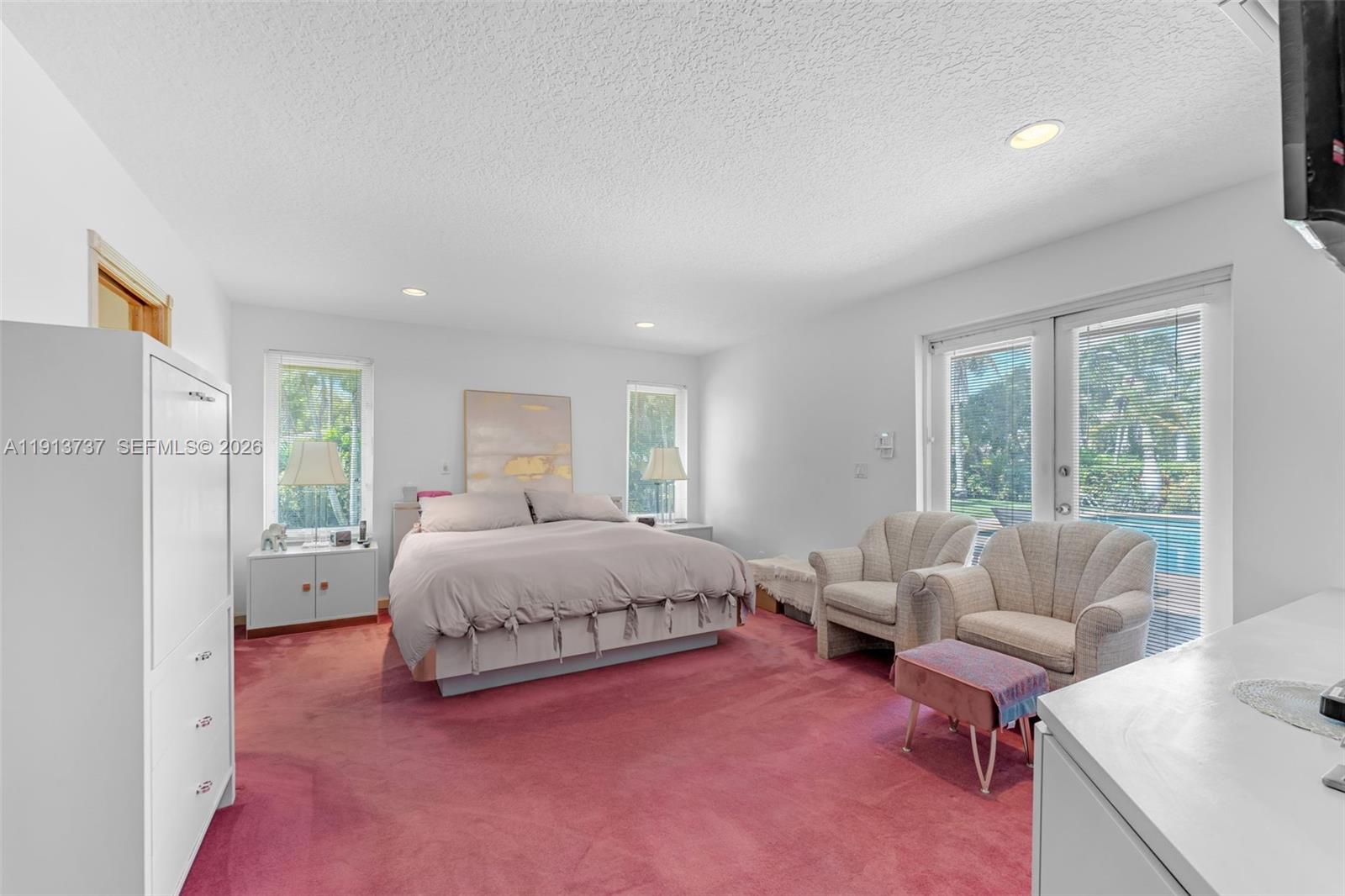 10220 Southwest 140th Street Miami, FL 33176 - Photo 21 of 53 a spacious bedroom with a bed and a couch