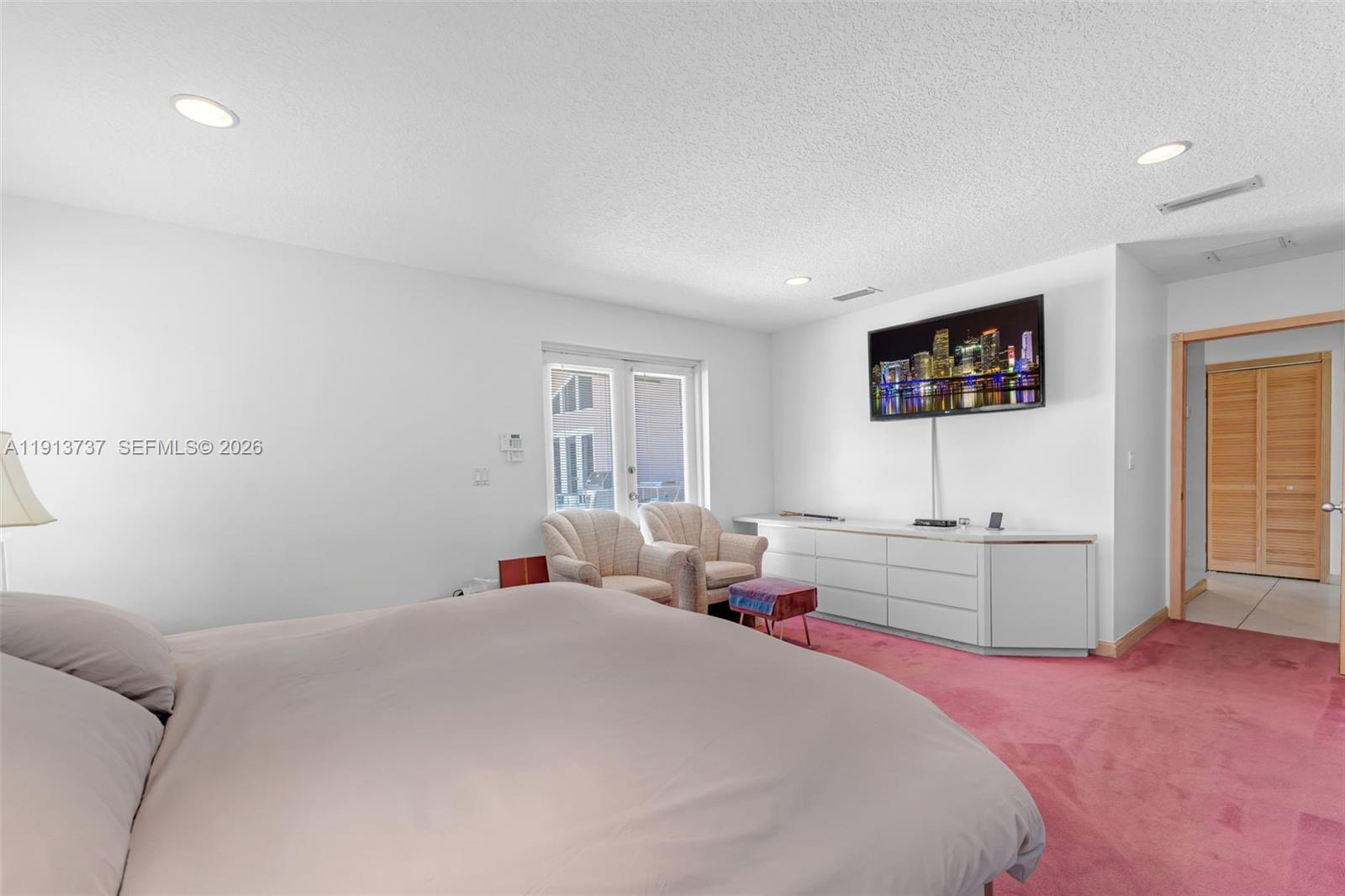 10220 Southwest 140th Street Miami, FL 33176 - Photo 22 of 53 a bedroom with a bed and a flat screen tv