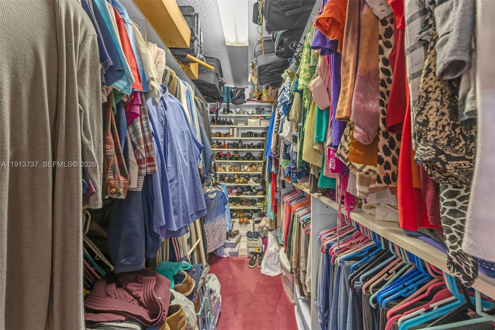 10220 Southwest 140th Street Miami, FL 33176 - Photo 23 of 53 a view of walk in closet with clothes