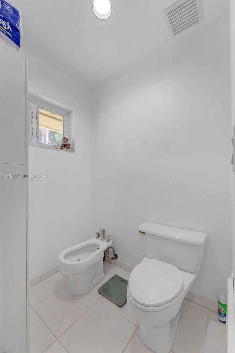 10220 Southwest 140th Street Miami, FL 33176 - Photo 27 of 53 a white toilet sitting next to a white cabinet