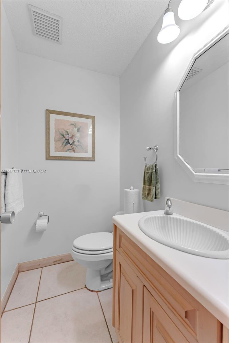 10220 Southwest 140th Street Miami, FL 33176 - Photo 33 of 53 a bathroom with a sink a toilet and a mirror