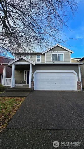 a kitchen with stainless steel appliances granite countertop a refrigerator a sink dishwasher a stove and white countertops with wooden floor