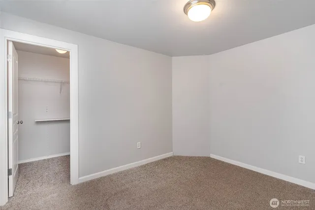 a bathroom with a granite countertop double vanity sink and mirror