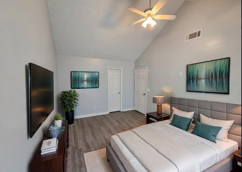 a bedroom with two beds and a flat screen tv