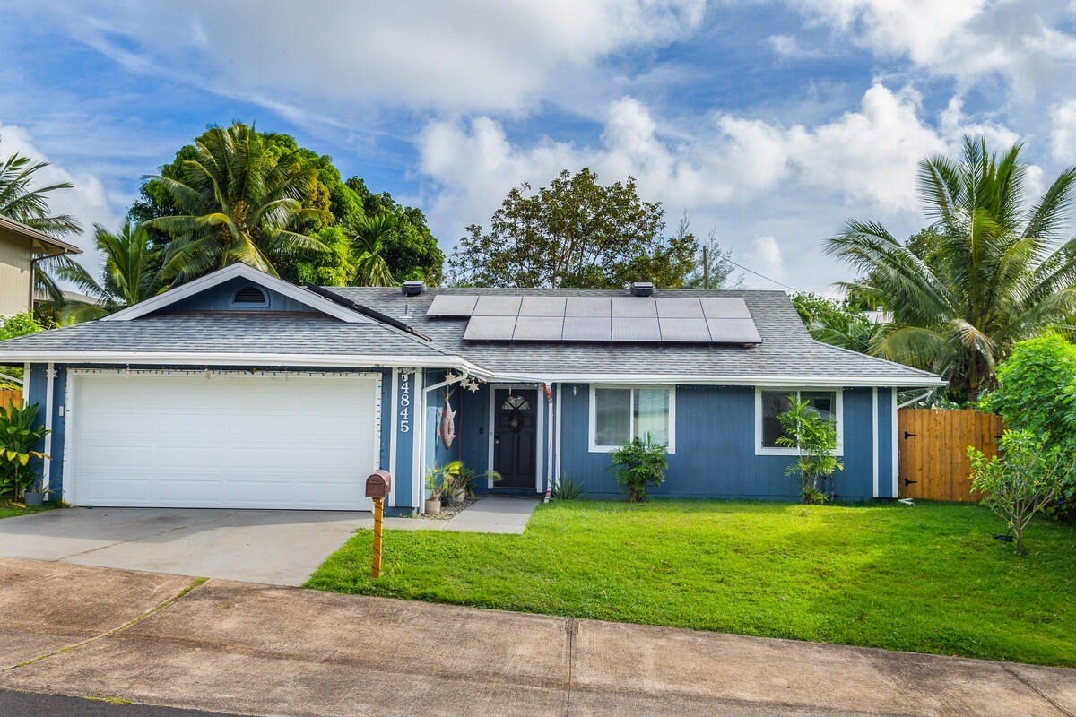 4845 Ohu Road Kapaa, HI 96746 - Photo 1 of 13 a front view of a house with a garden and plants