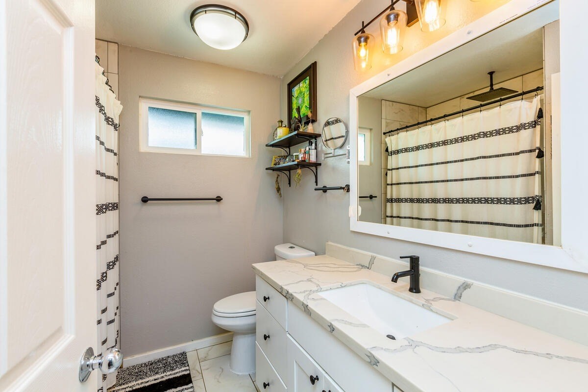 4845 Ohu Road Kapaa, HI 96746 - Photo 8 of 13 a bathroom with a granite countertop sink toilet and shower