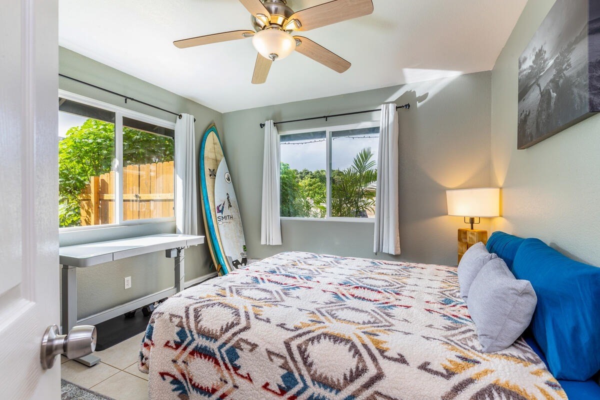 4845 Ohu Road Kapaa, HI 96746 - Photo 9 of 13 a bedroom with a large bed and a chandelier