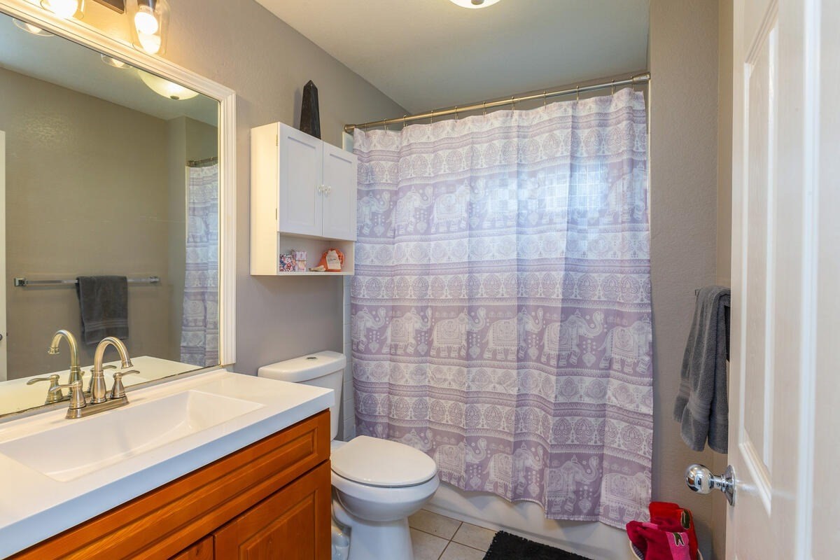4845 Ohu Road Kapaa, HI 96746 - Photo 10 of 13 a bathroom with a sink and a mirror