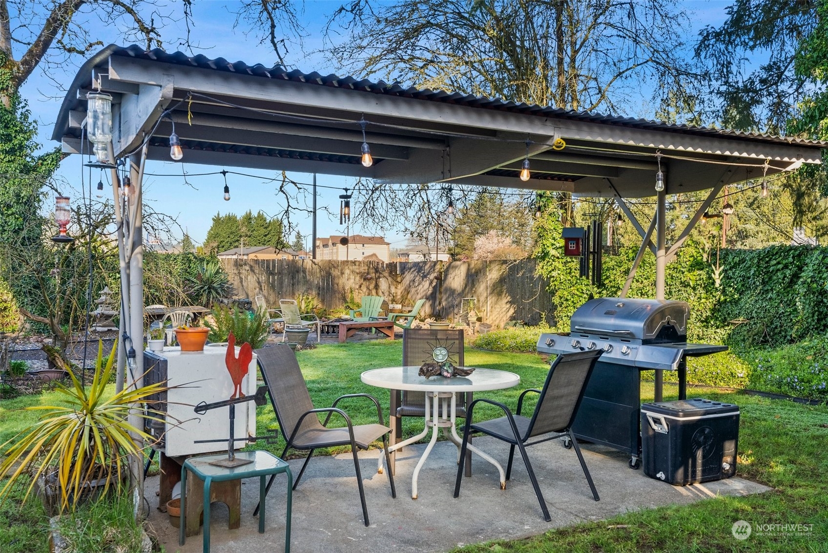 809 Long Road Centralia, WA 98531 - Photo 26 of 37 a view of patio with table and chairs potted plants and a palm tree