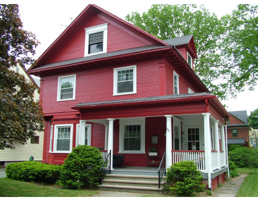 66 Garfield Street Springfield, MA 01108 - Photo 1 of 12 a view of a house with a small yard plants and a large tree