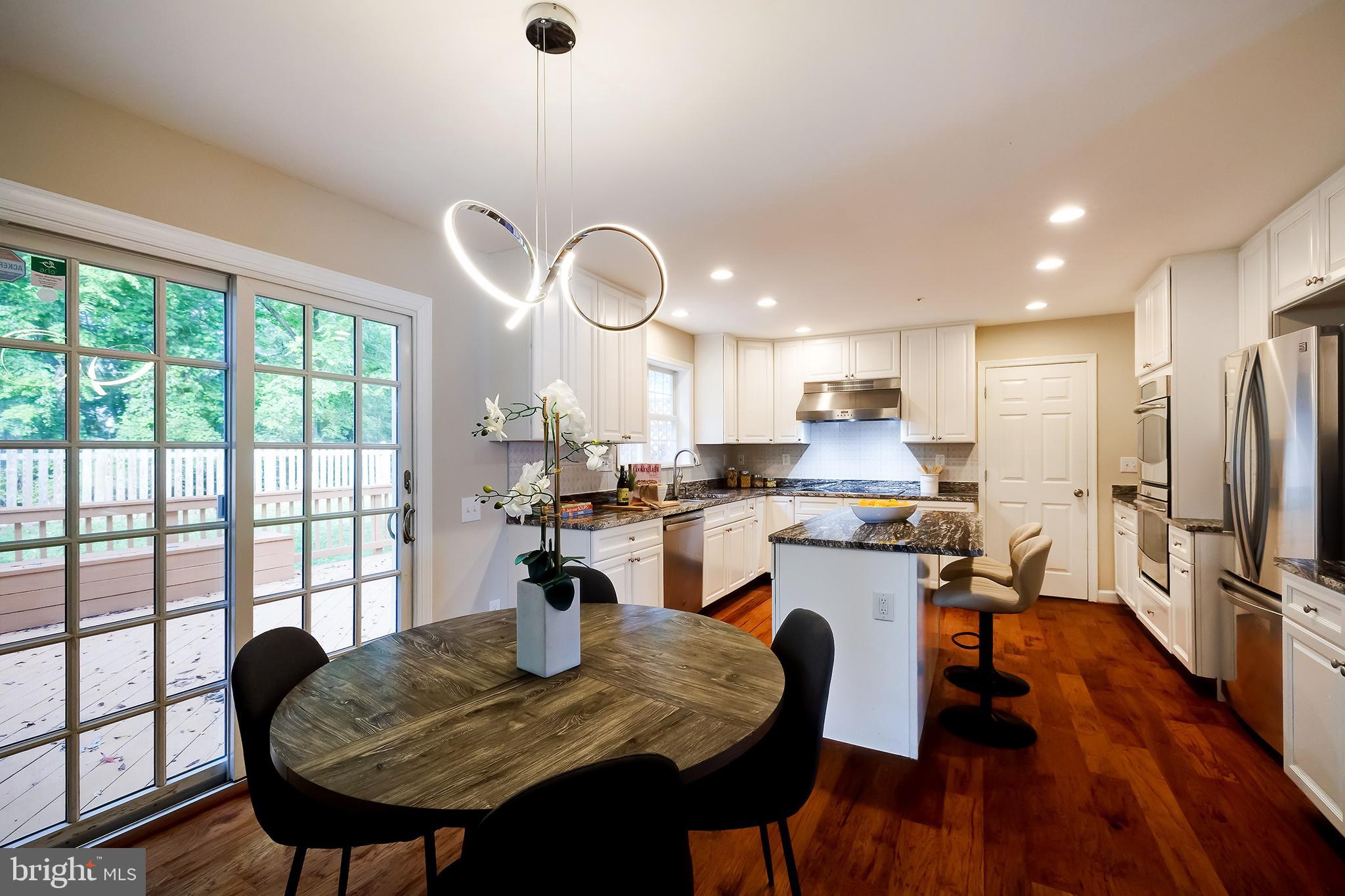 7428 Quail Ridge Lane Bowie, MD 20720 - Photo 20 of 87 a view of a dining room with furniture window and wooden floor