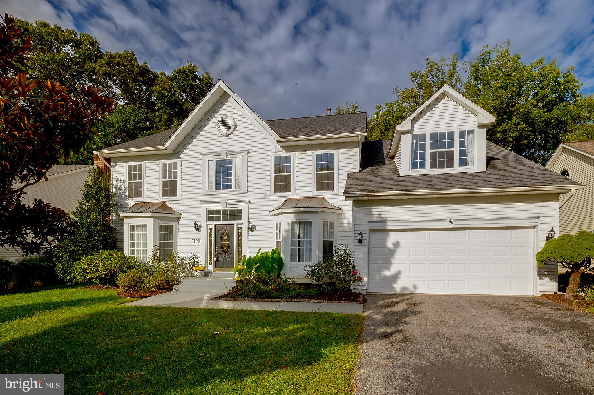 7428 Quail Ridge Lane Bowie, MD 20720 - Photo 2 of 87 a front view of a house with a yard and garage