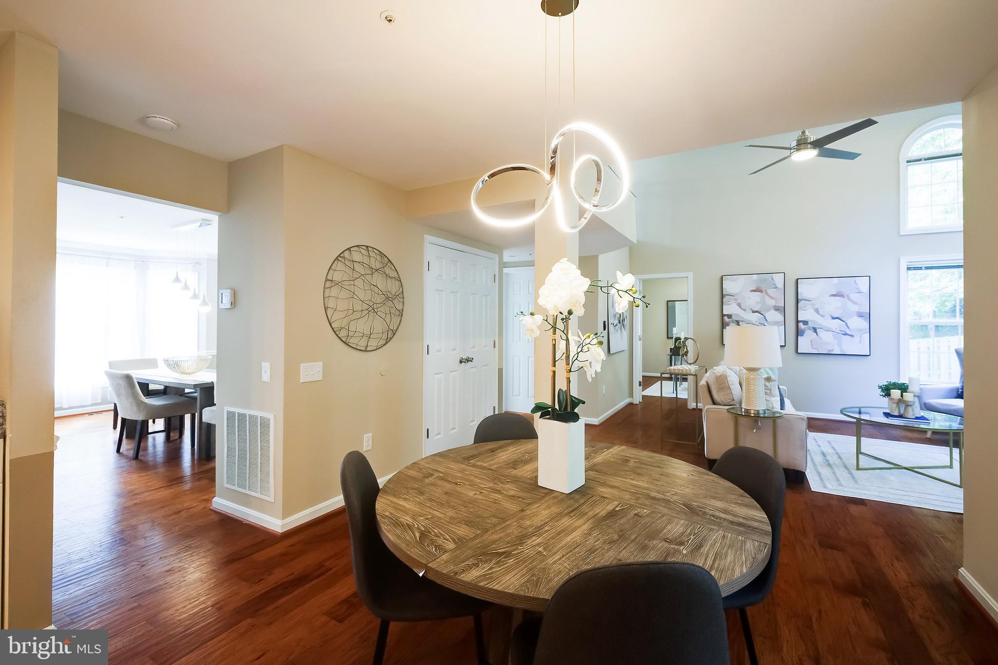 7428 Quail Ridge Lane Bowie, MD 20720 - Photo 22 of 87 a view of a dining room with furniture and wooden floor
