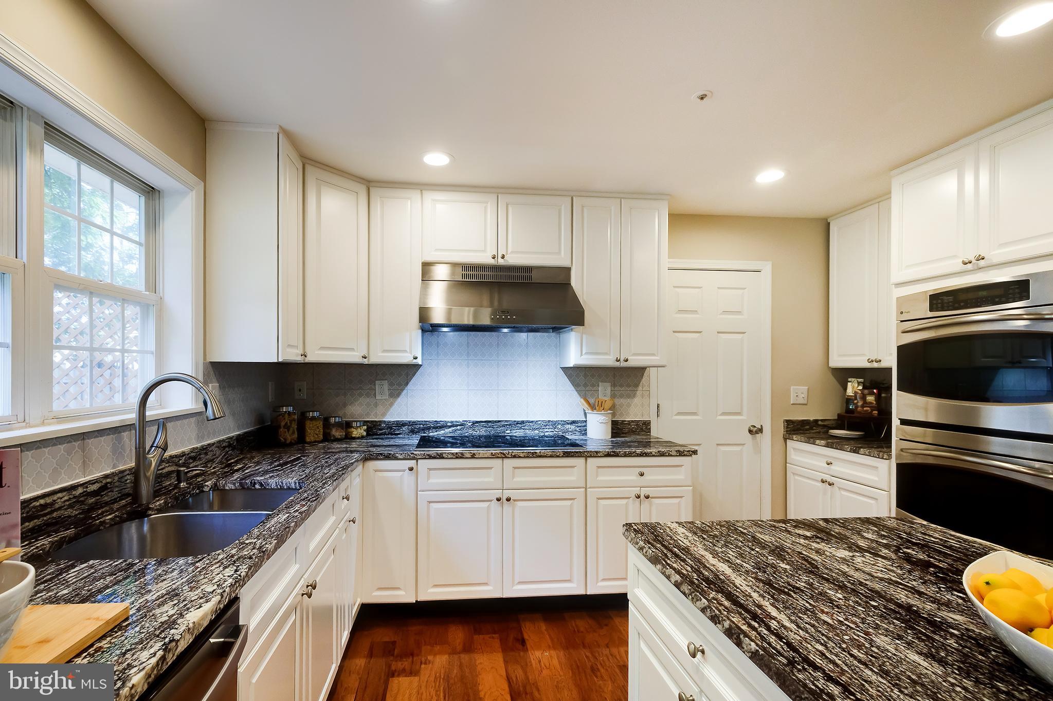 7428 Quail Ridge Lane Bowie, MD 20720 - Photo 28 of 87 a kitchen with a sink stove top oven and refrigerator