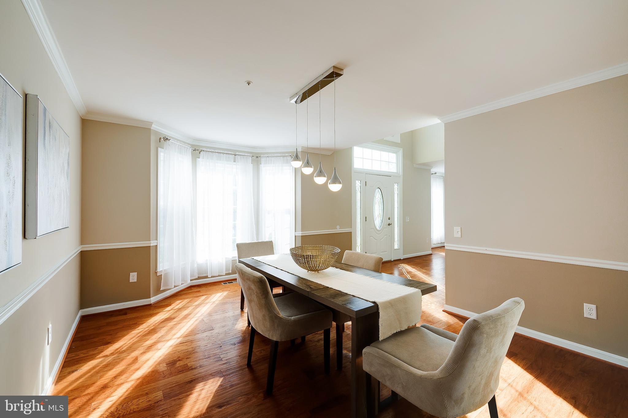 7428 Quail Ridge Lane Bowie, MD 20720 - Photo 29 of 87 a dining room with furniture and wooden floor