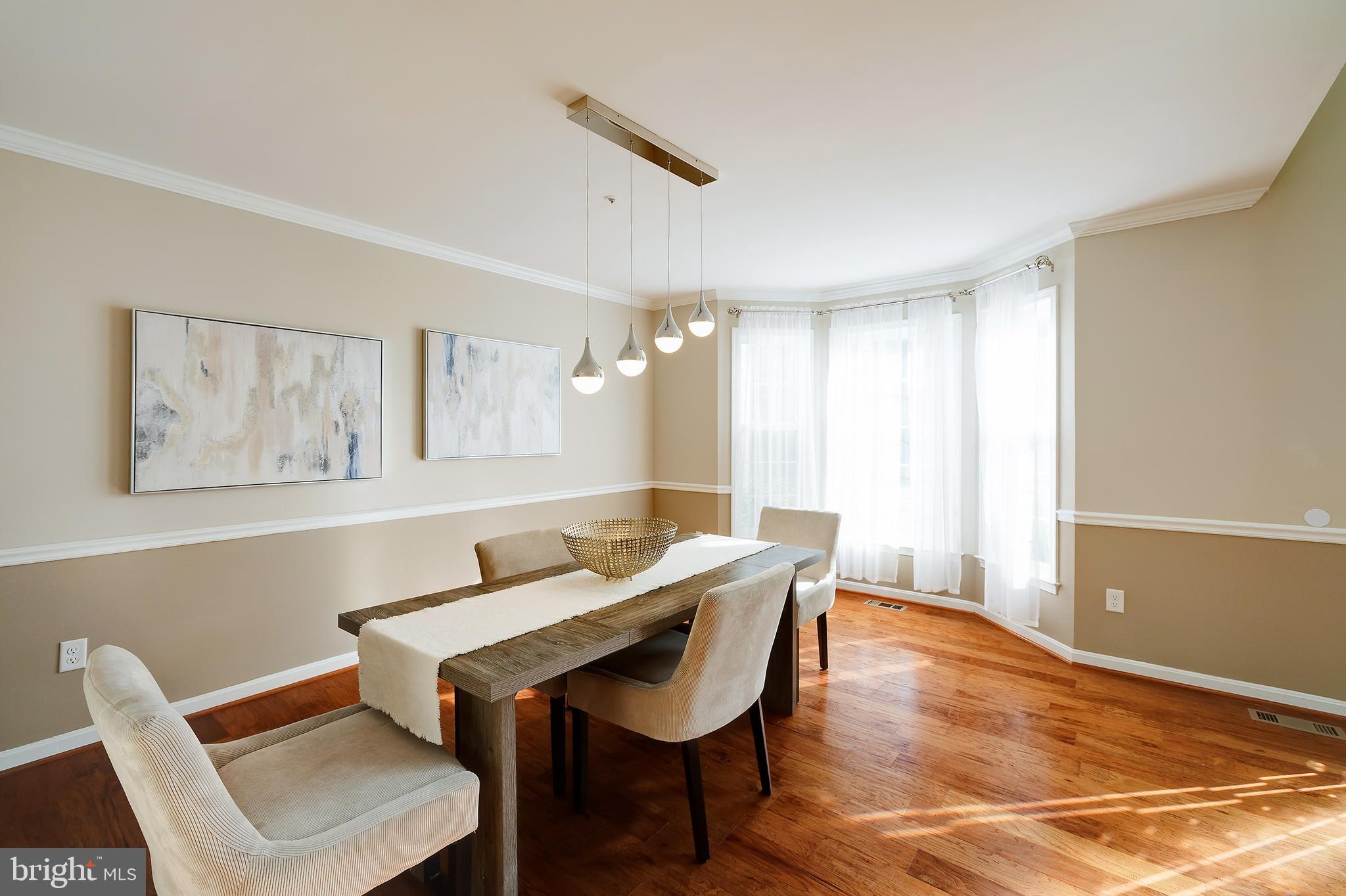 7428 Quail Ridge Lane Bowie, MD 20720 - Photo 30 of 87 a view of a dining room with furniture and wooden floor