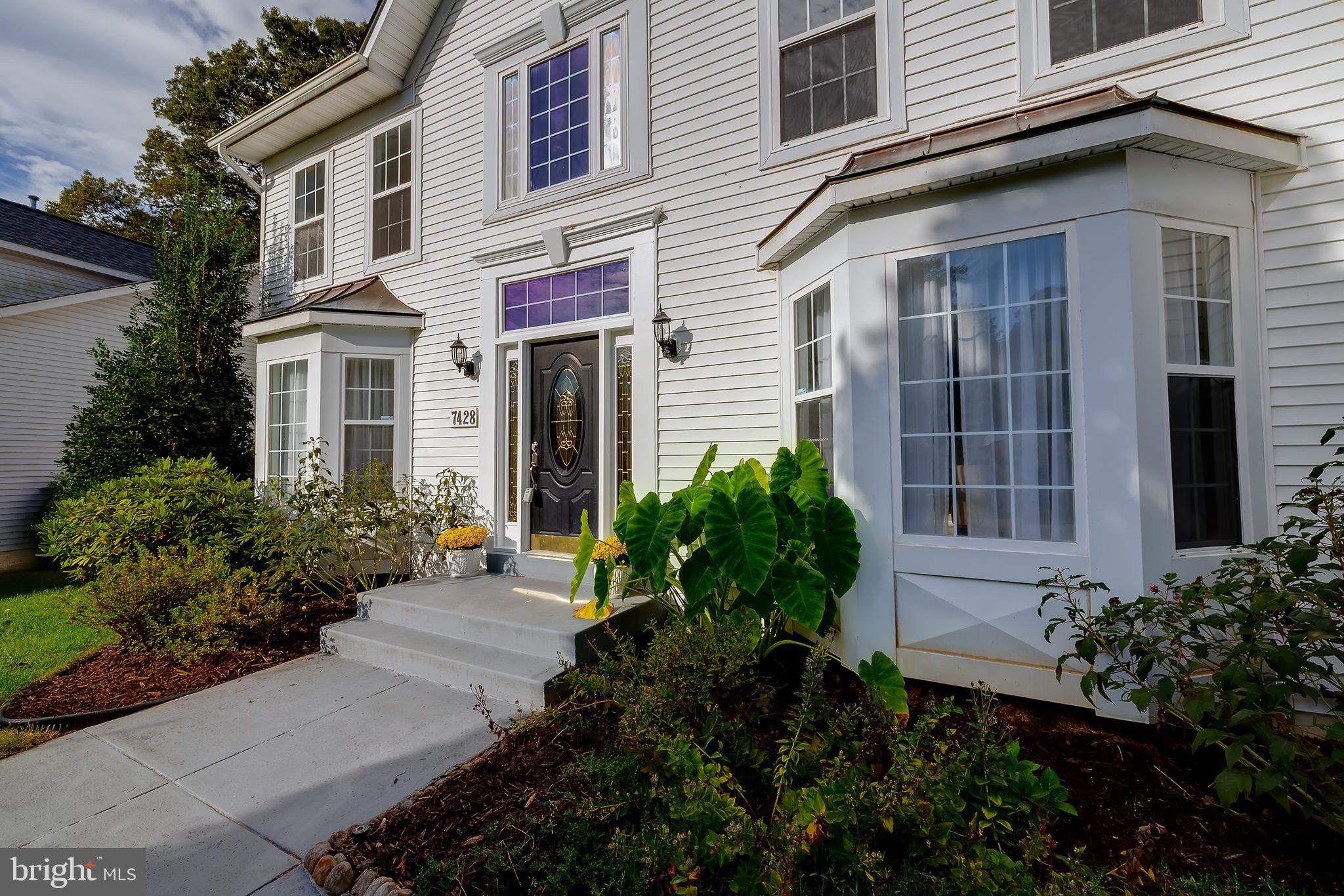 7428 Quail Ridge Lane Bowie, MD 20720 - Photo 3 of 87 a view of a house with potted plants and a bench