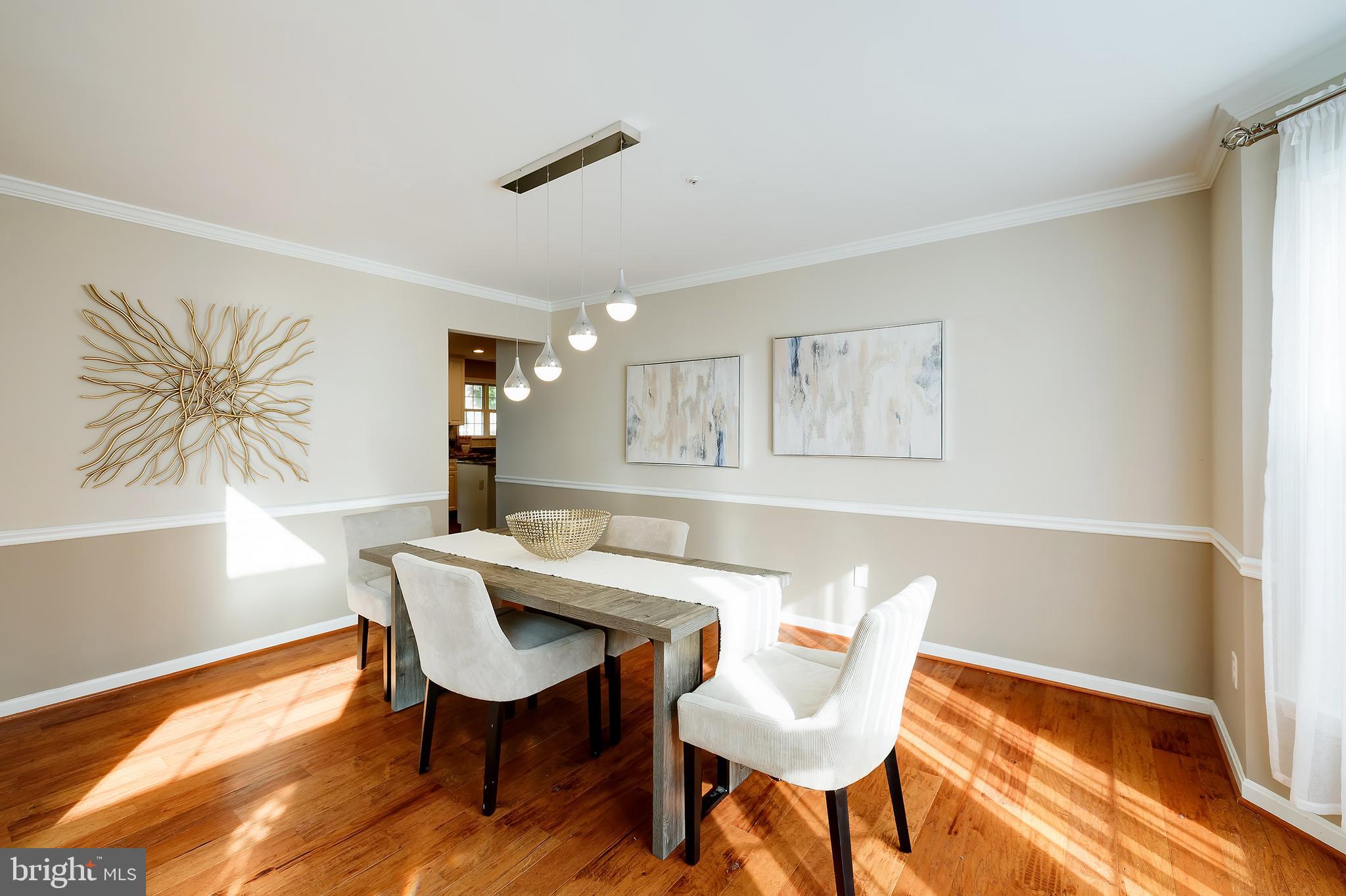 7428 Quail Ridge Lane Bowie, MD 20720 - Photo 31 of 87 a view of a dining room with furniture and wooden floor