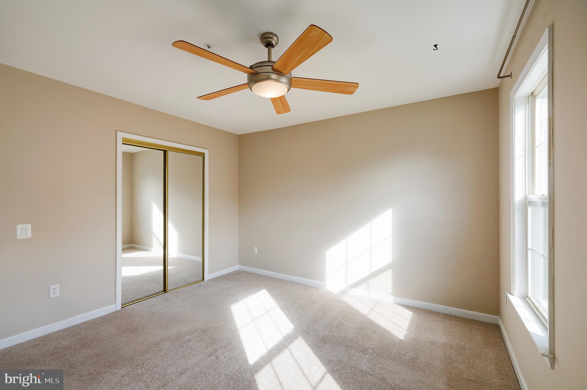 7428 Quail Ridge Lane Bowie, MD 20720 - Photo 37 of 87 a view of a big room with a windows and ceiling fan