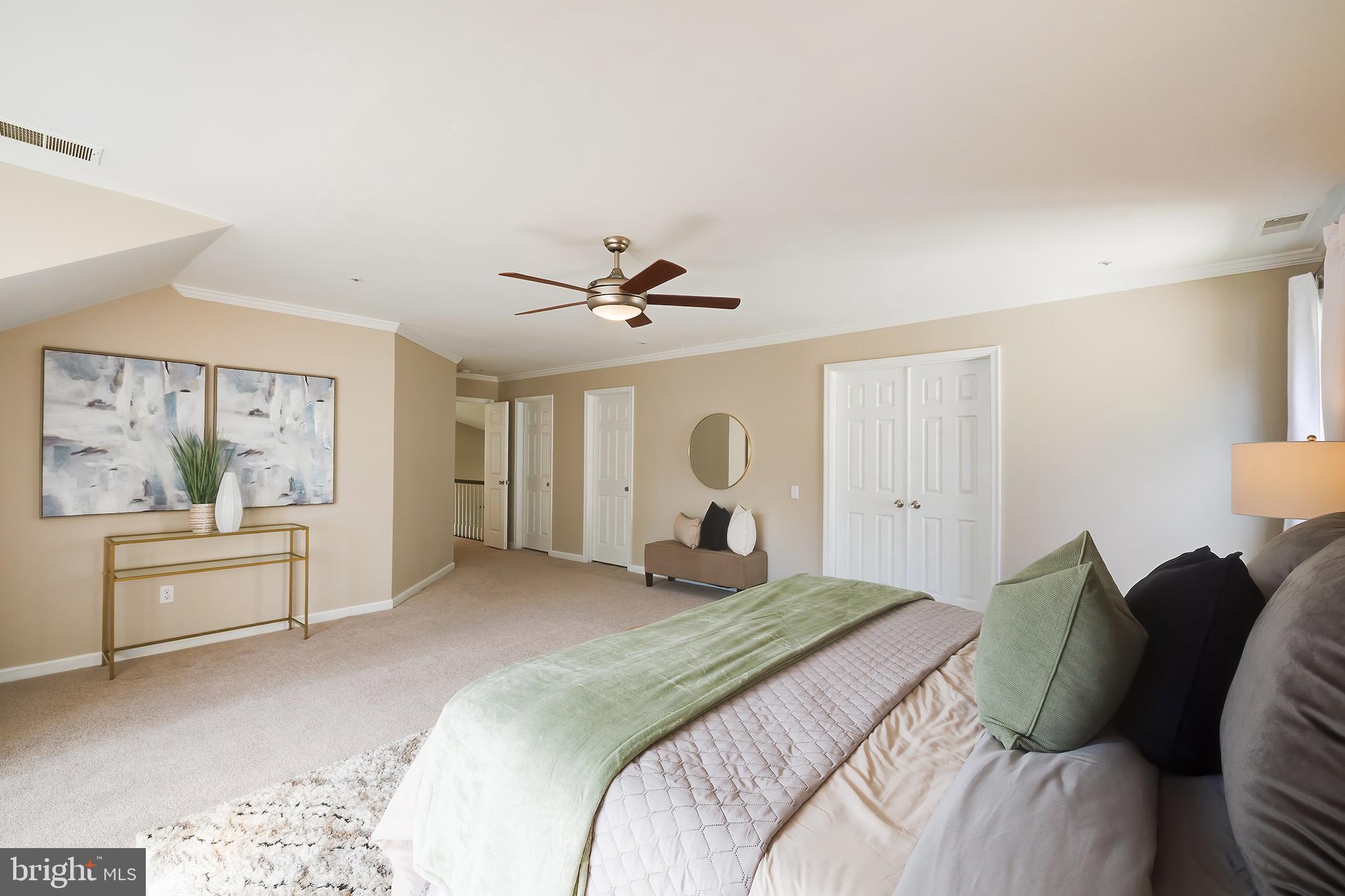 7428 Quail Ridge Lane Bowie, MD 20720 - Photo 47 of 87 a bedroom with a large bed and a chandelier