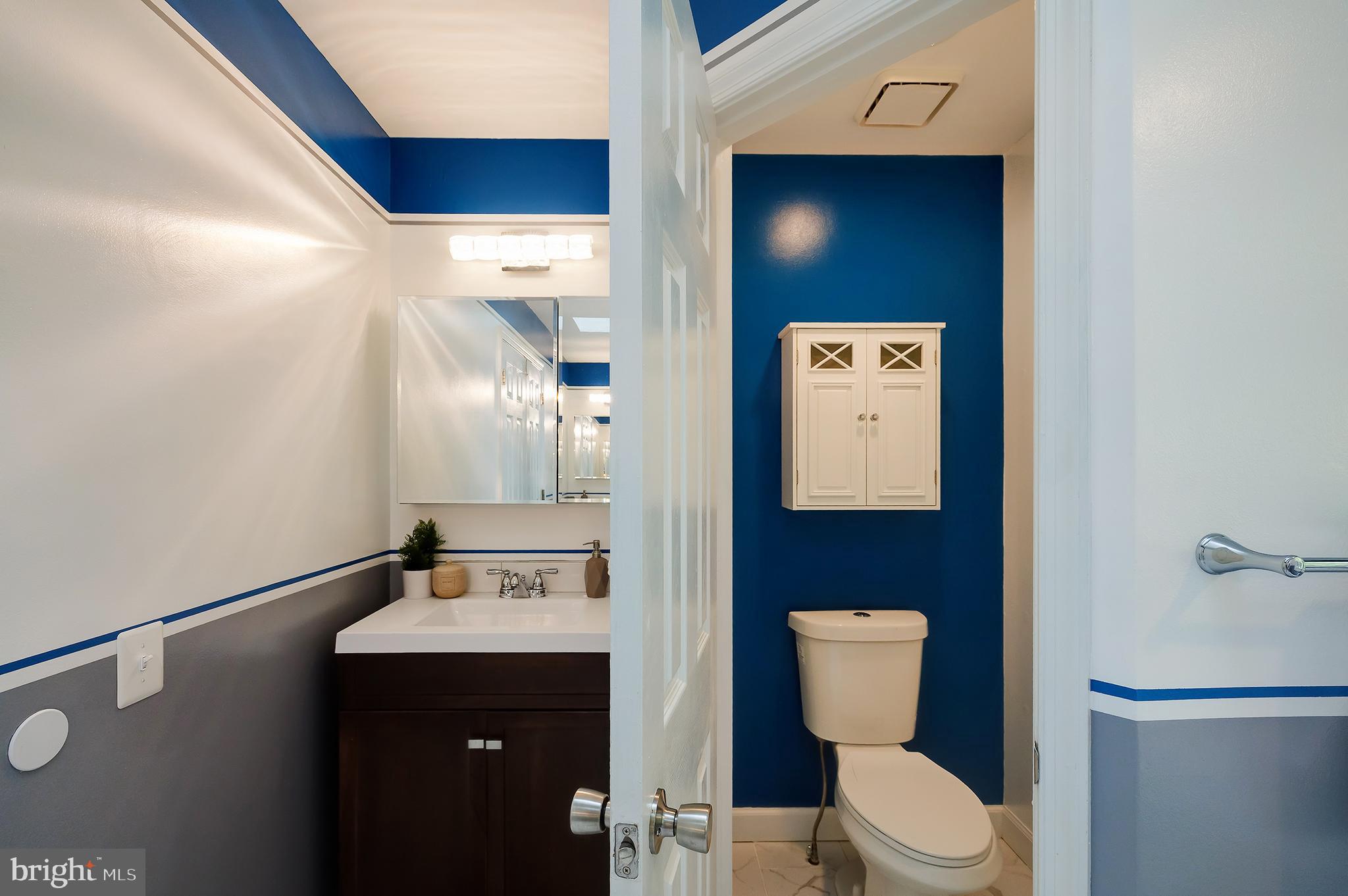 7428 Quail Ridge Lane Bowie, MD 20720 - Photo 58 of 87 a bathroom with a toilet sink and mirror