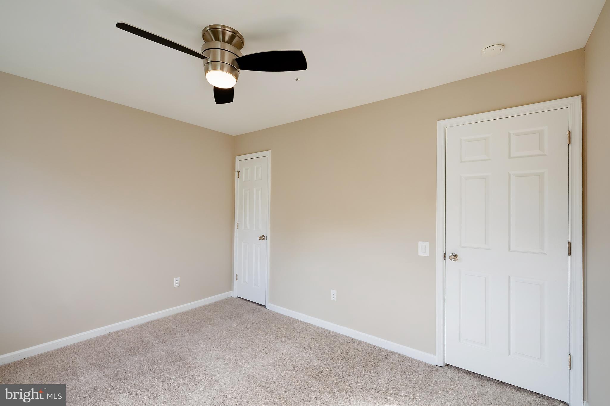 7428 Quail Ridge Lane Bowie, MD 20720 - Photo 64 of 87 an empty room with a ceiling fan