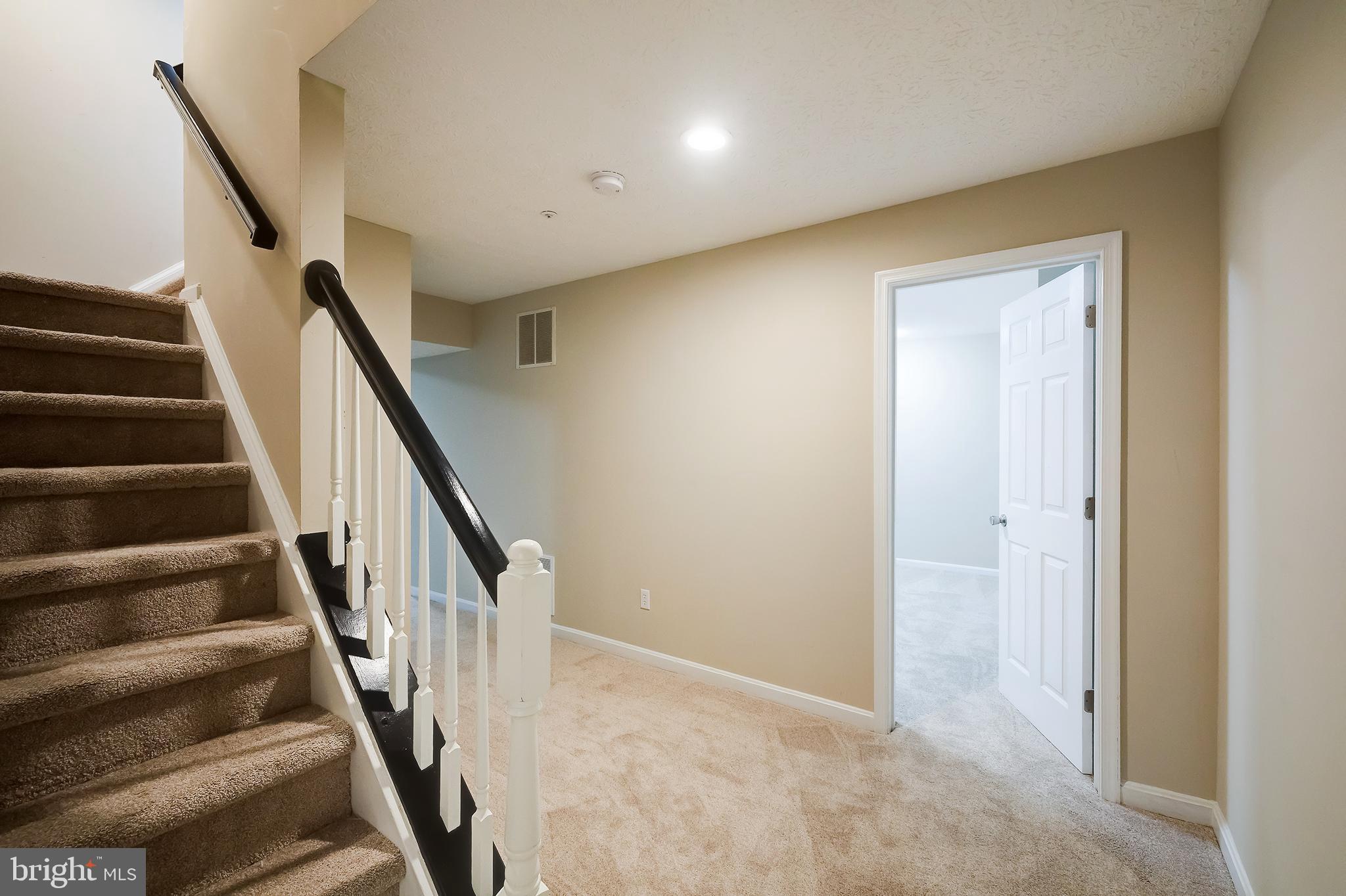 7428 Quail Ridge Lane Bowie, MD 20720 - Photo 66 of 87 a view of staircase with wooden floor and white walls