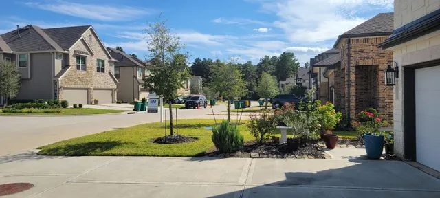 a front view of a house with a yard and fountain