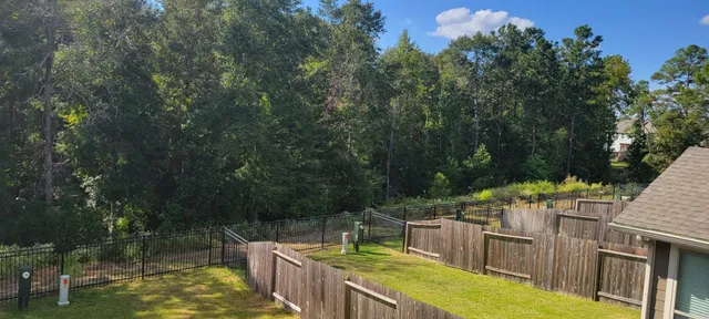 a view of a wooden deck and backyard
