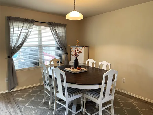 a view of a dining room with furniture and window