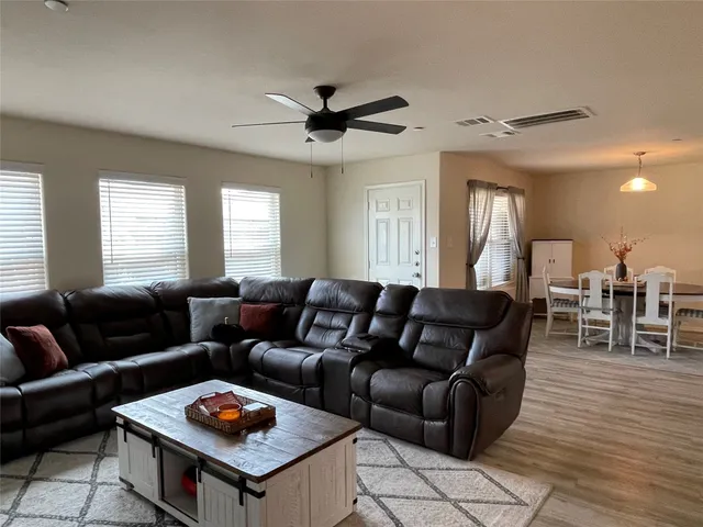 a living room with furniture a wooden floor and a table