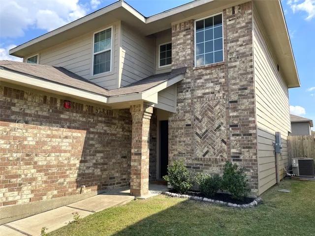 a view of a brick house with a large windows