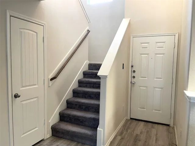 a view of entryway with wooden floor and stairs