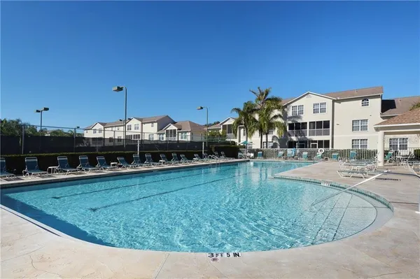 a view of a swimming pool with outdoor seating